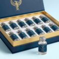 A premium, gold-lined presentation box containing multiple vials of GHK-Cu 100mg peptide, demonstrating professional laboratory supply by Resurrection Peptides.