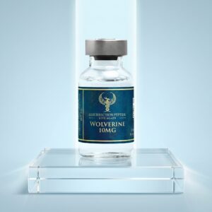 A high-end studio product photograph of a Wolverine 10MG vial standing centered on a frosted glass pedestal, highlighted by a dramatic top spotlight against a smooth blue gradient background.